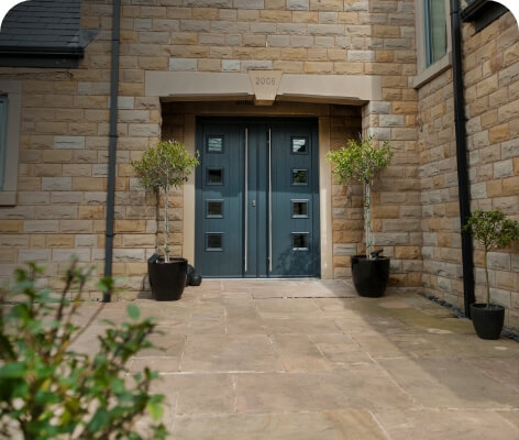 modern aluminium entrance door on a long sandstone driveway