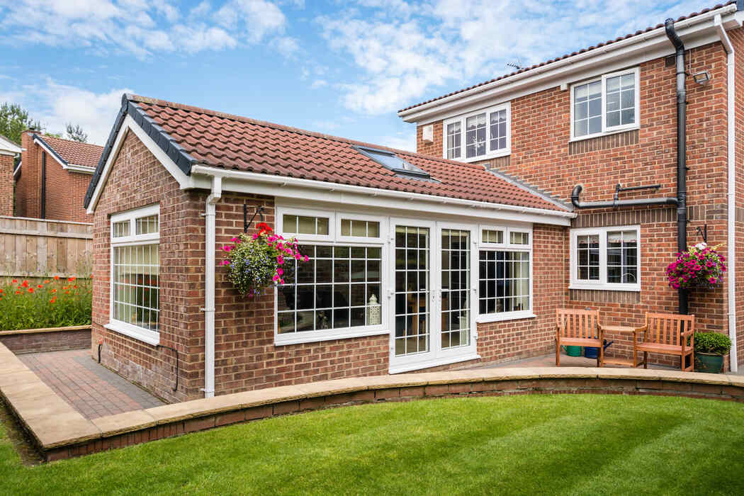 red clay colour tiled roof extension with cross bead white uPVC