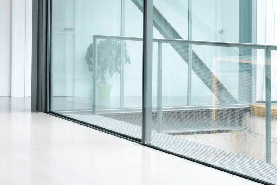 aluminium black sliding doors interior with a railing and a white floor
