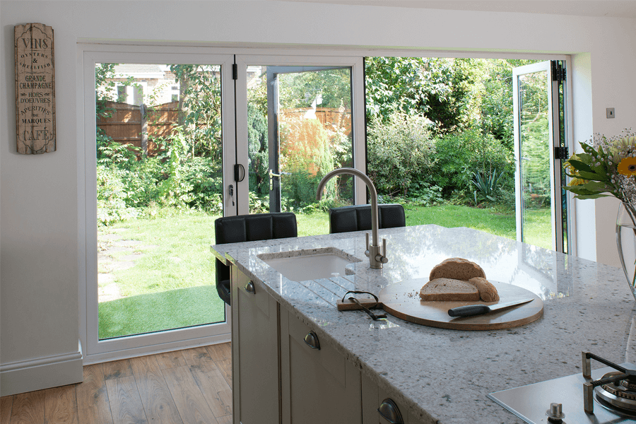 white uPVC bi-fold doors open kitchen interior