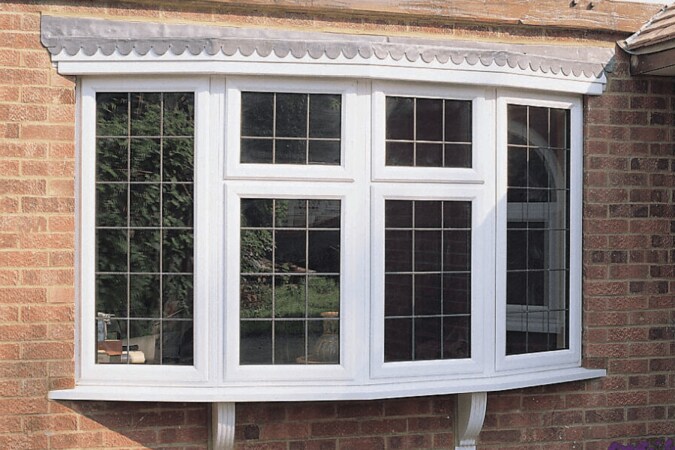 bow window white uPVC on a brick house