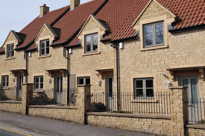 uPVC flush sash windows on a fenced off house