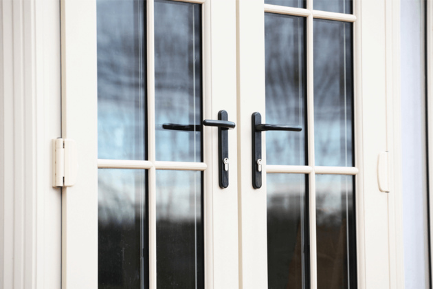 white uPVC french doors with black handles close up