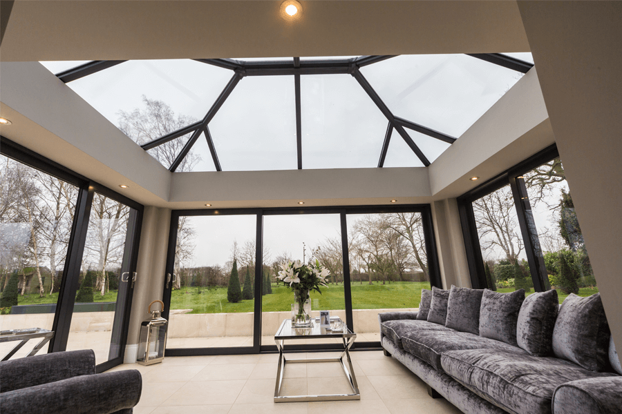orangery with black aluminum roof and windows looking up view