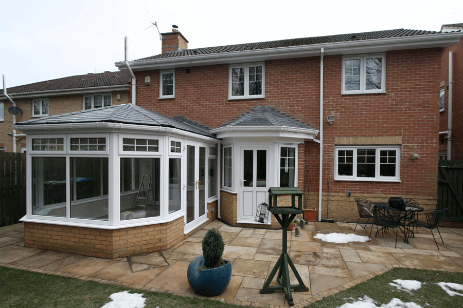 black tiled roof white uPVC conservatory house