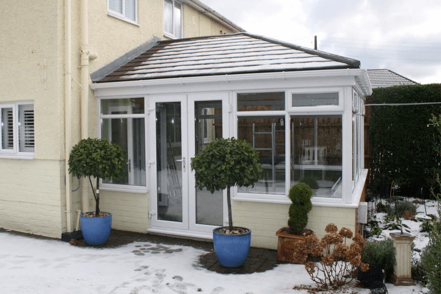 tiled roof on a white uPVC conservatory snow