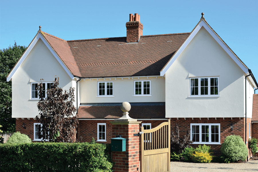 white uPVC flush sash windows on a exposed brick and cream painted house