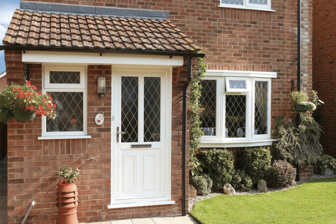 white uPVC entrance door in front of bay window